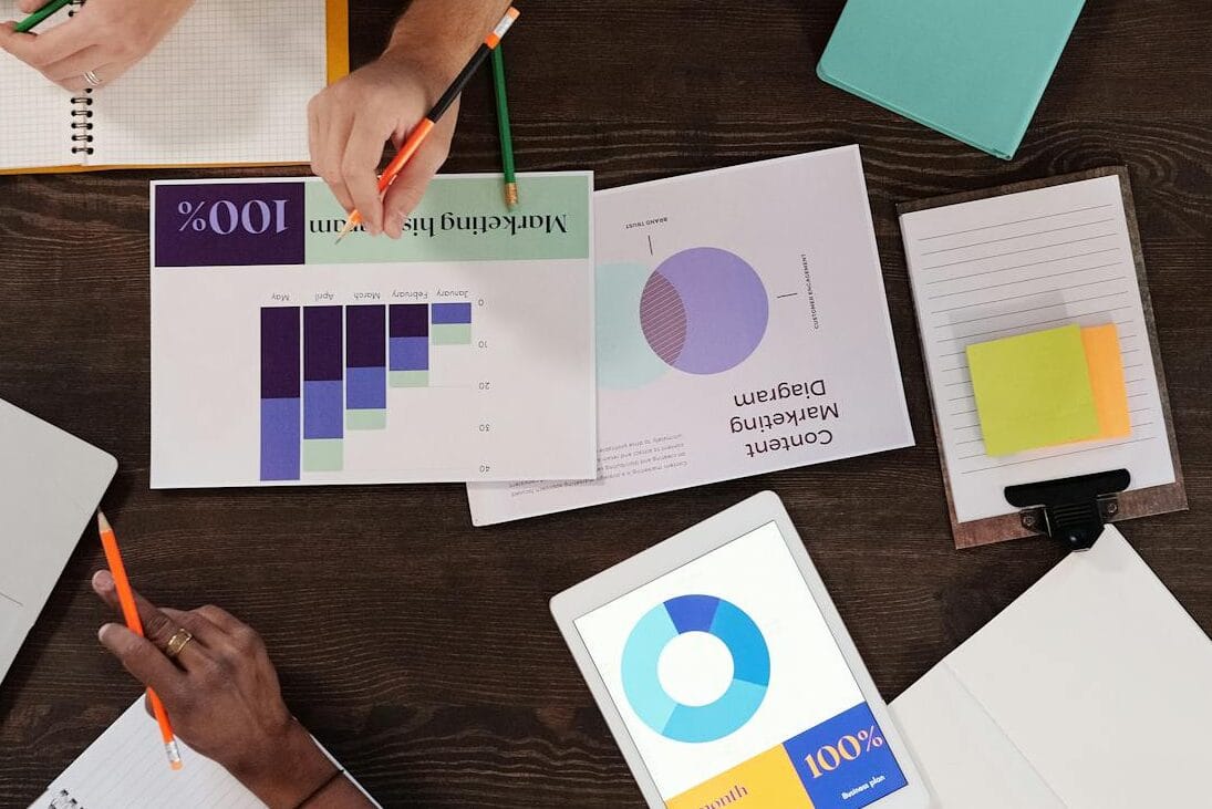 Overhead view of a diverse team collaborating on a project in a modern office setting.